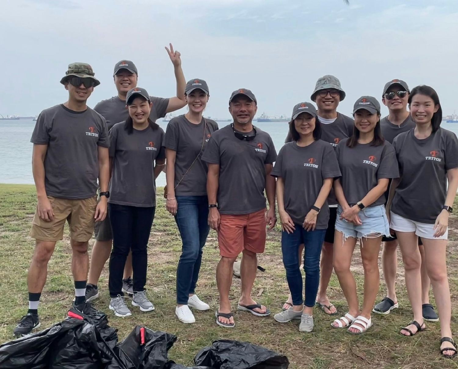 Volunteers from our Singapore team taking a break from beach cleanup efforts. One of Triton's 21 global offices. 