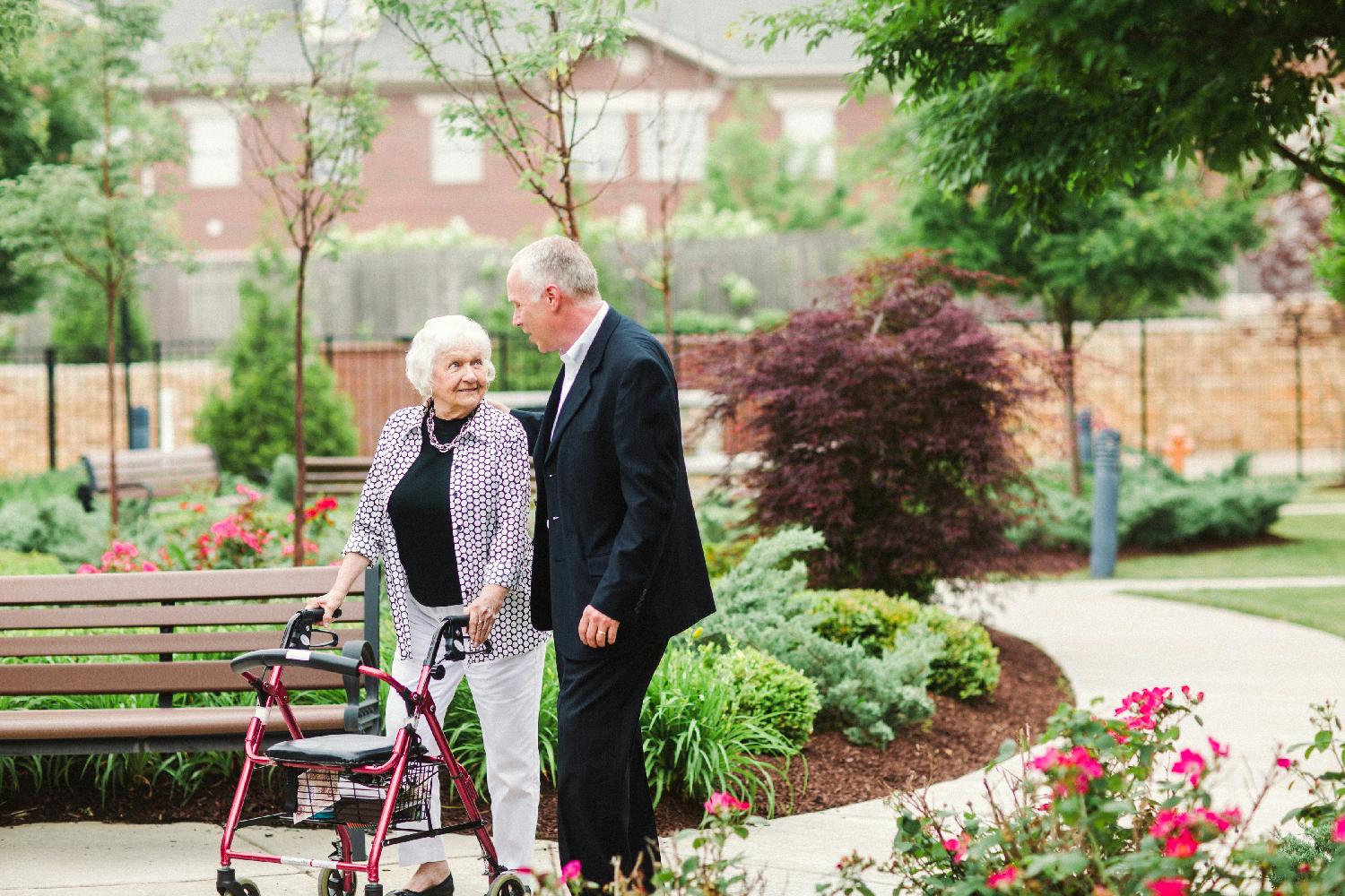 A senior couple takes a walk through the community’s courtyard.