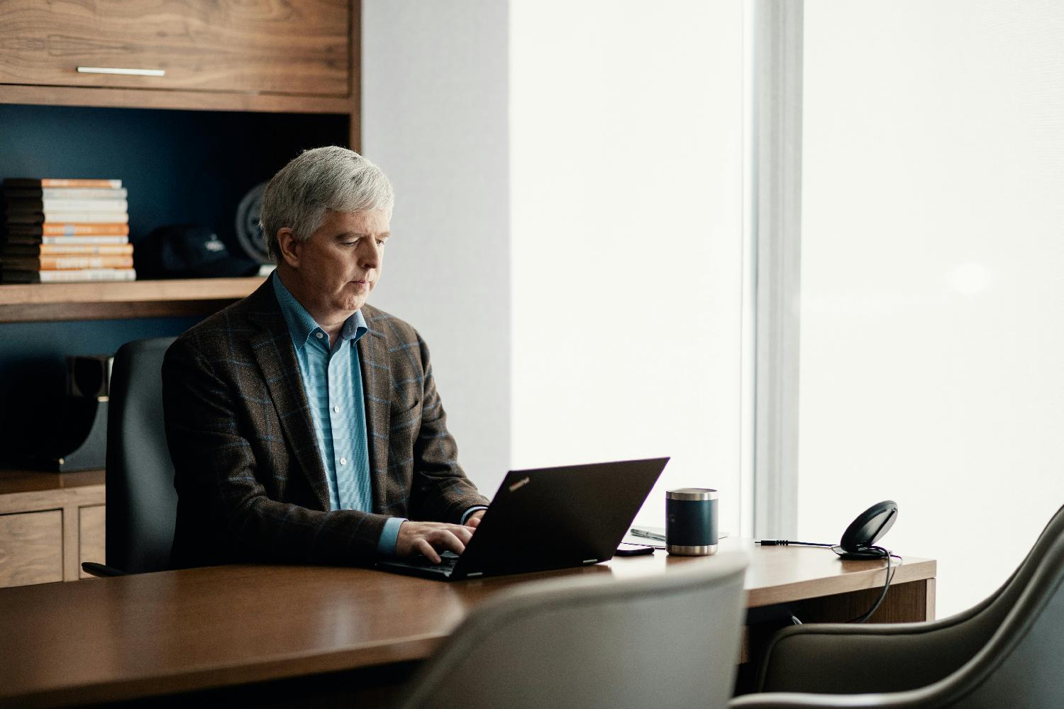 Shawn Sweeney, Spinnaker CEO, catches up on some work in his office.