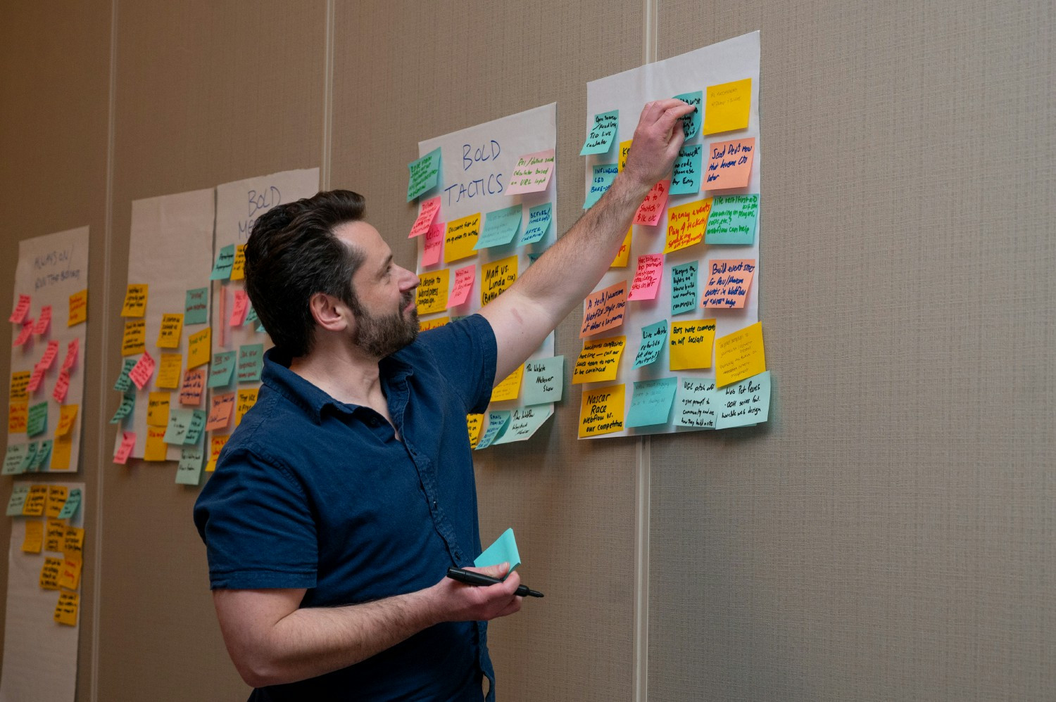 A Webflow team member participates in a group brainstorming discussion at a recent offsite.