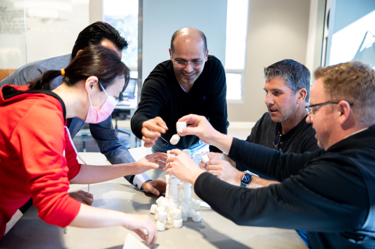 Team members play an ice-breaking game during an annual retreat.