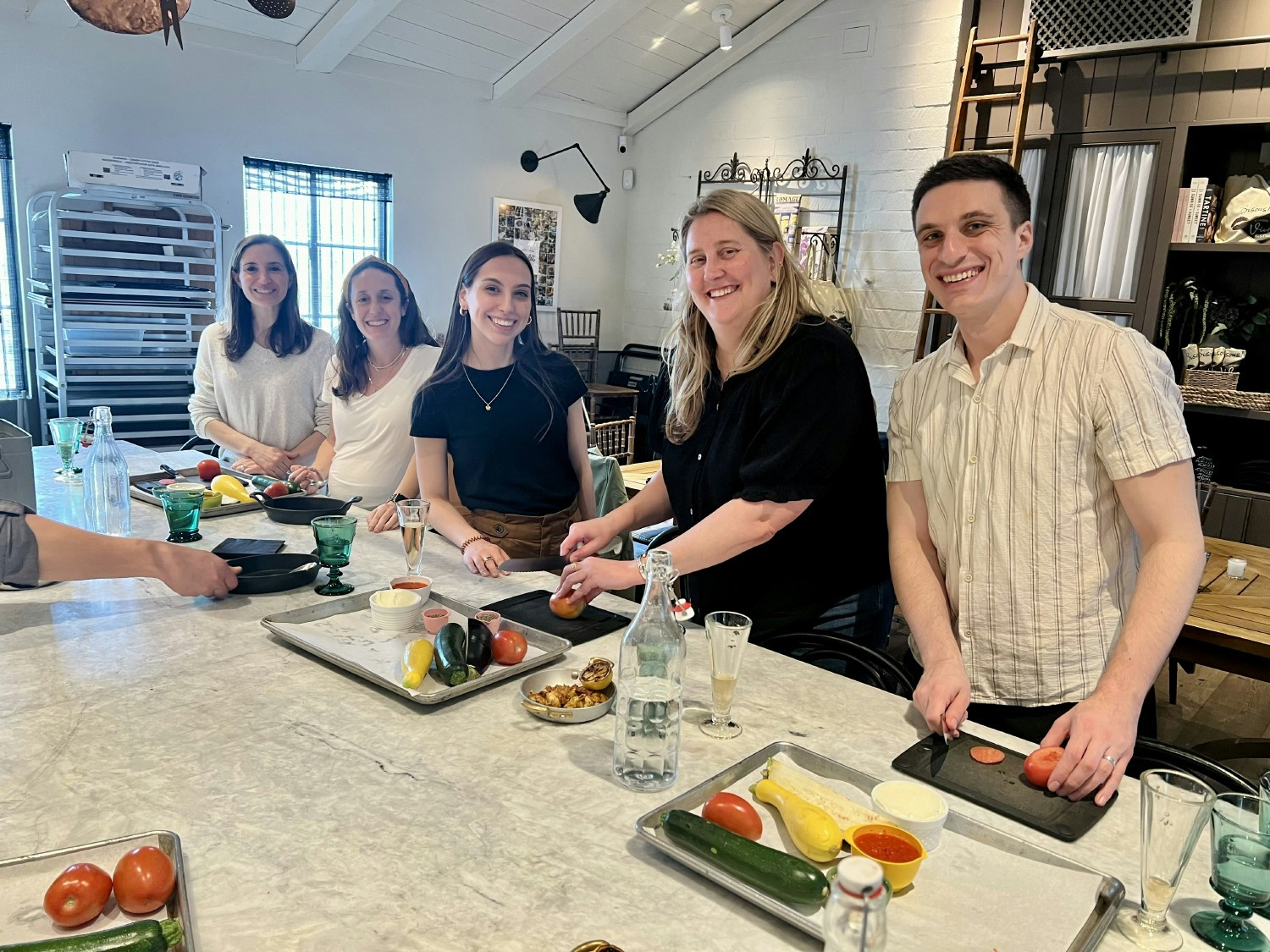 Generous Brands Marketing team preparing a meal together at a private cooking class.
