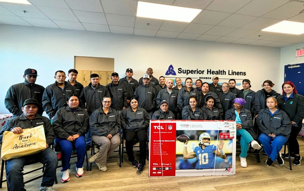 HLSG, Superior Health Linens team  received jackets and pictured with their raffle item as a thank you for their work.