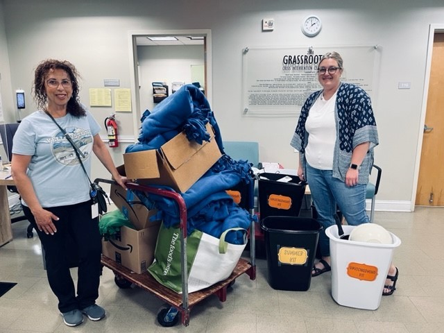 Two of Medisolv's employees dropping off the blankets, backpacks, toiletries, etc. to Grassroots - May 2023