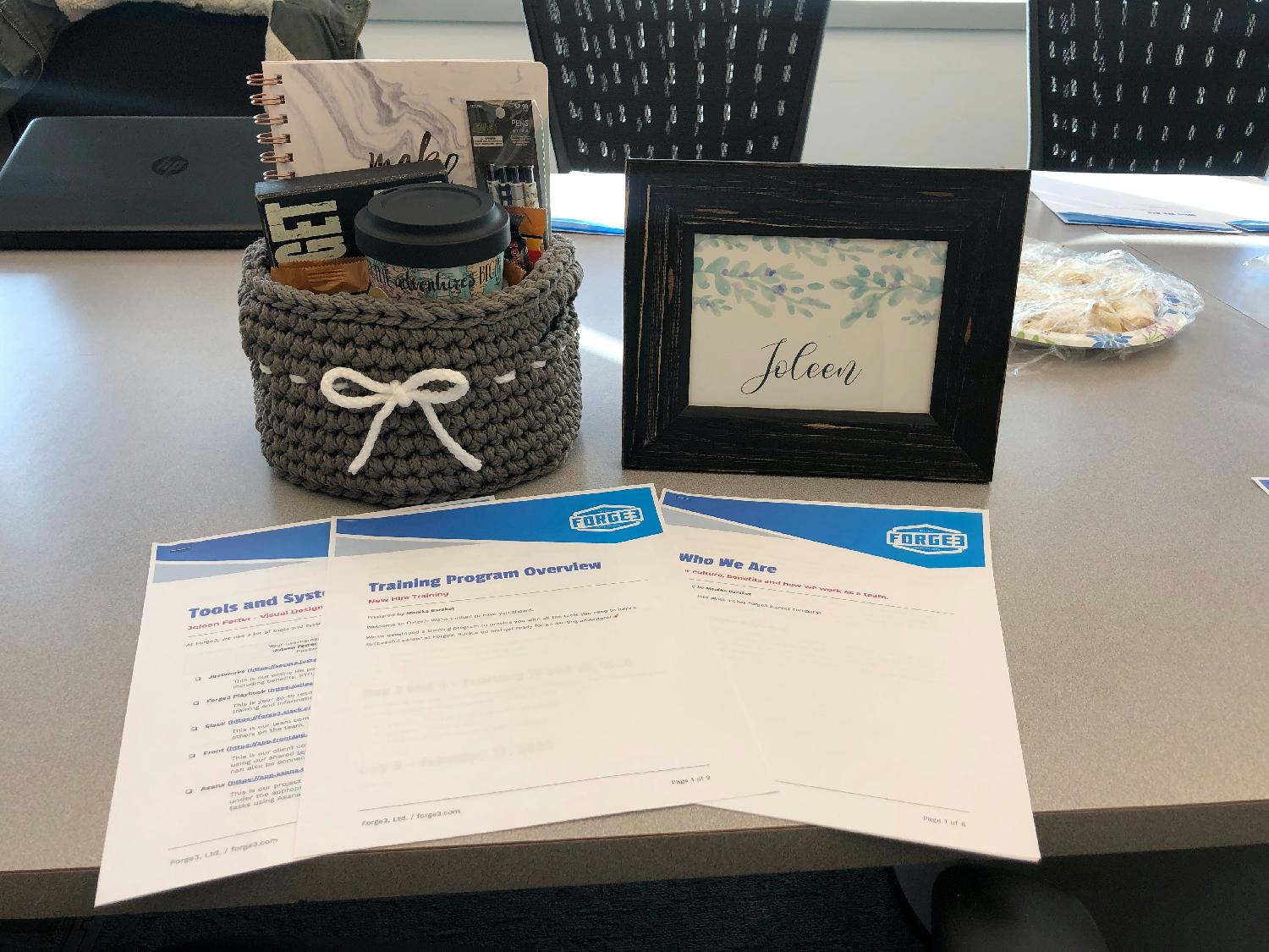 How we welcome new people to our team. The basket is handmade by our Chief Production Officer and the framed art is hand drawn by one of our designers. We stock the basket full of goodies. 