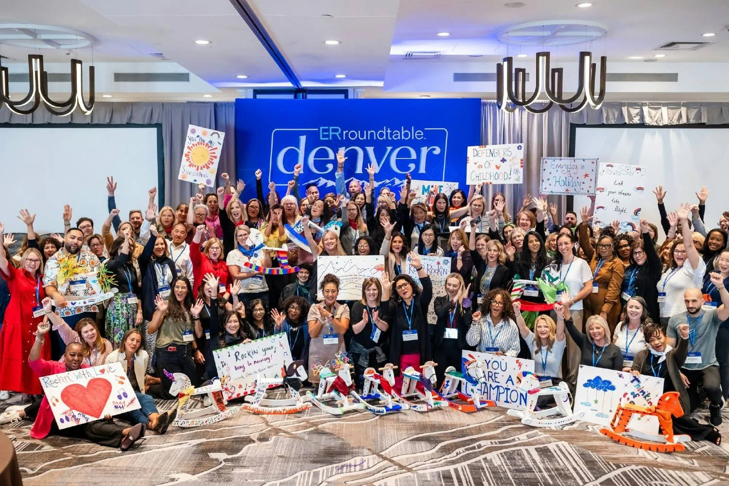 2024 Roundtable in Denver Colorado Over 100 global ER leaders making rocking horses to donate to the children's hospital