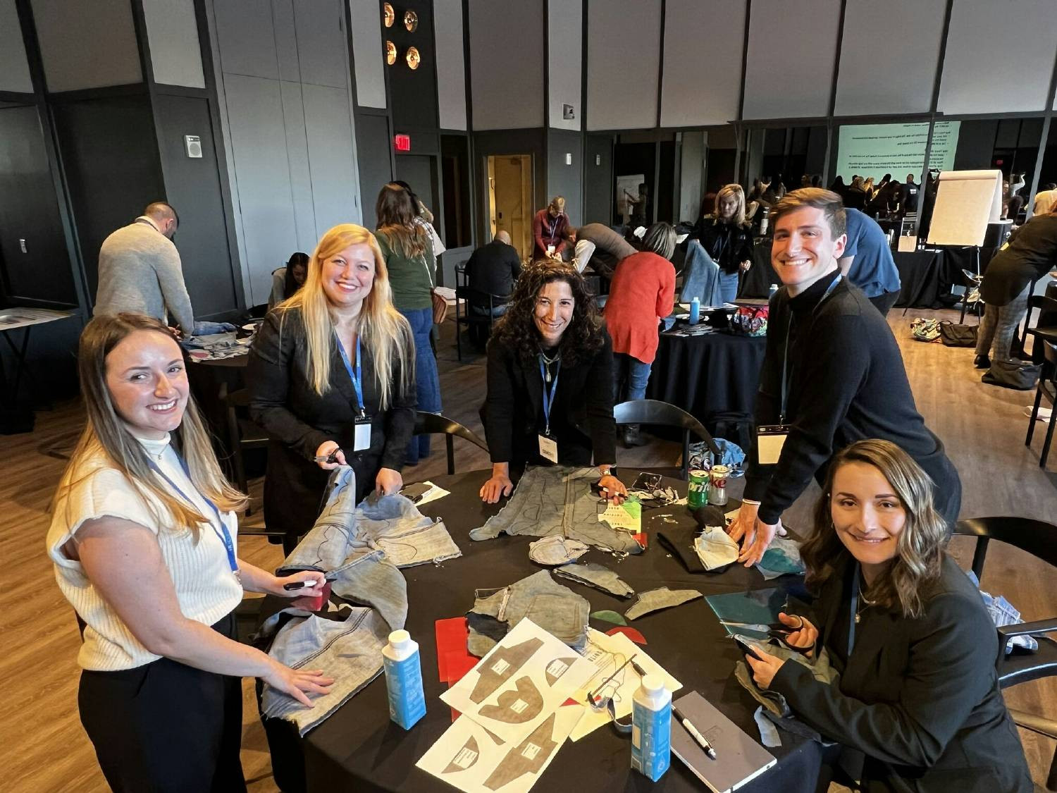 Team members engaging in a volunteer opportunity through Sole Hope at CEKO 2024. Creating shoes for people in need.