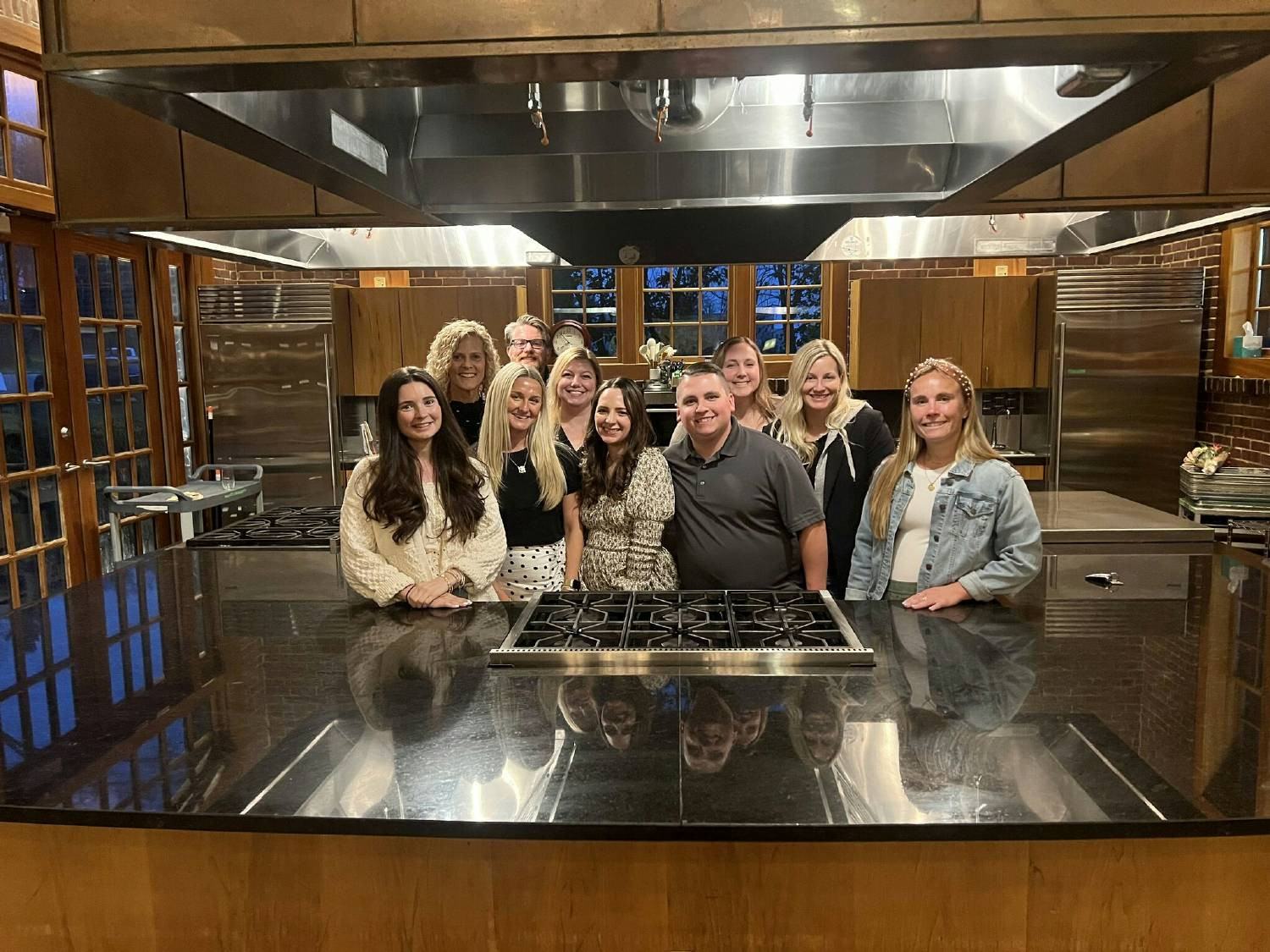 The marketing team taking a cooking class as a team building activity after a productive team onsite session.