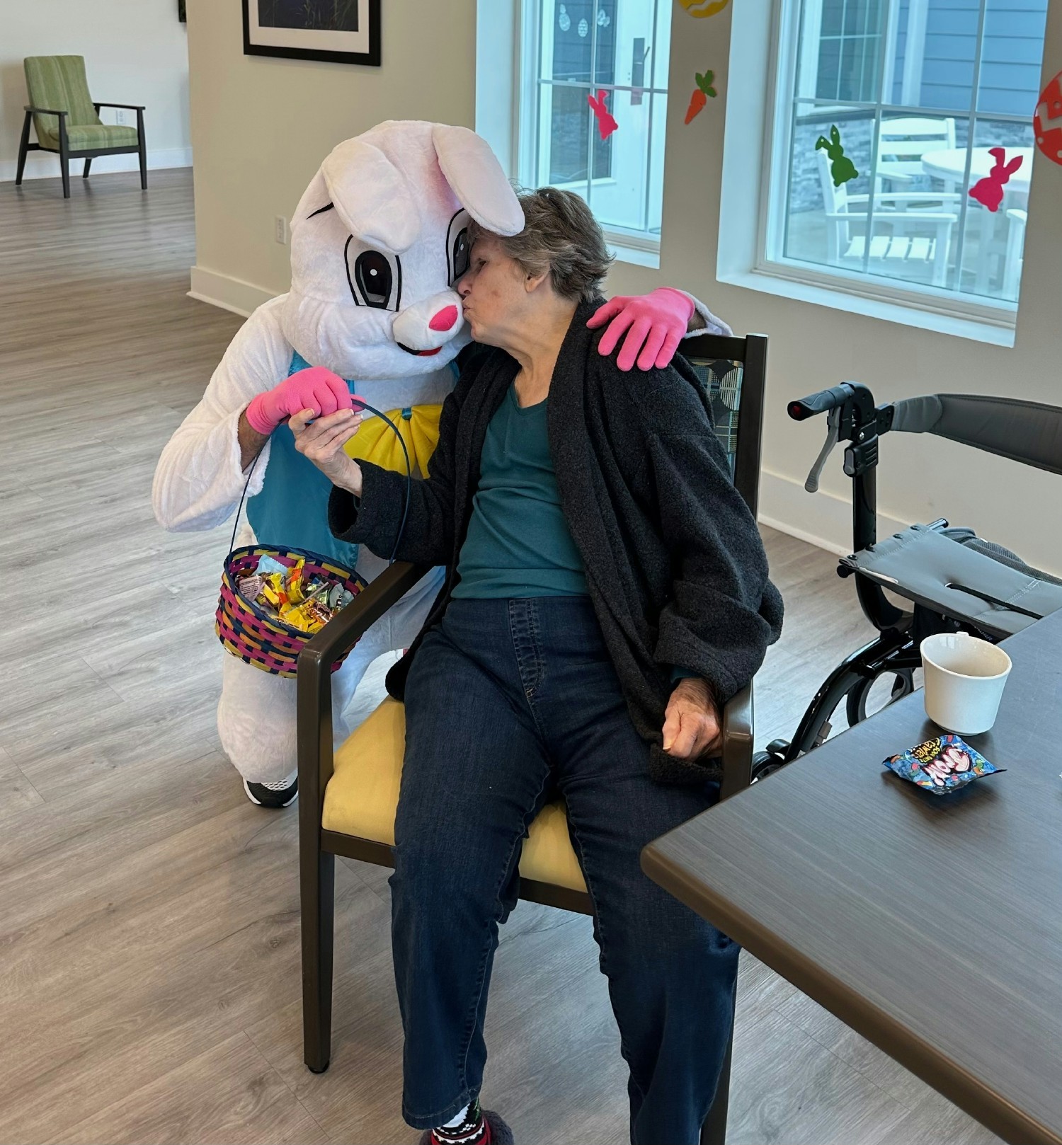 The Reliant at Home Easter Bunny bringing hugs and kisses to a senior community resident.