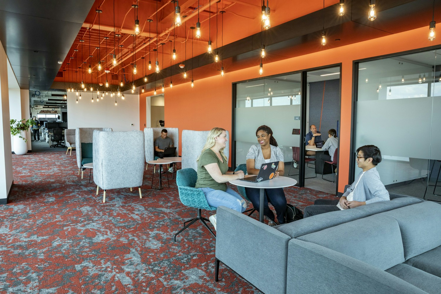 DraftKings team members using one of the many huddle spaces in the office.