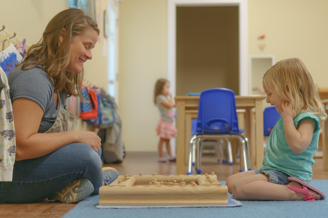 Ms. Kari with one of her Primary students, giving a lesson