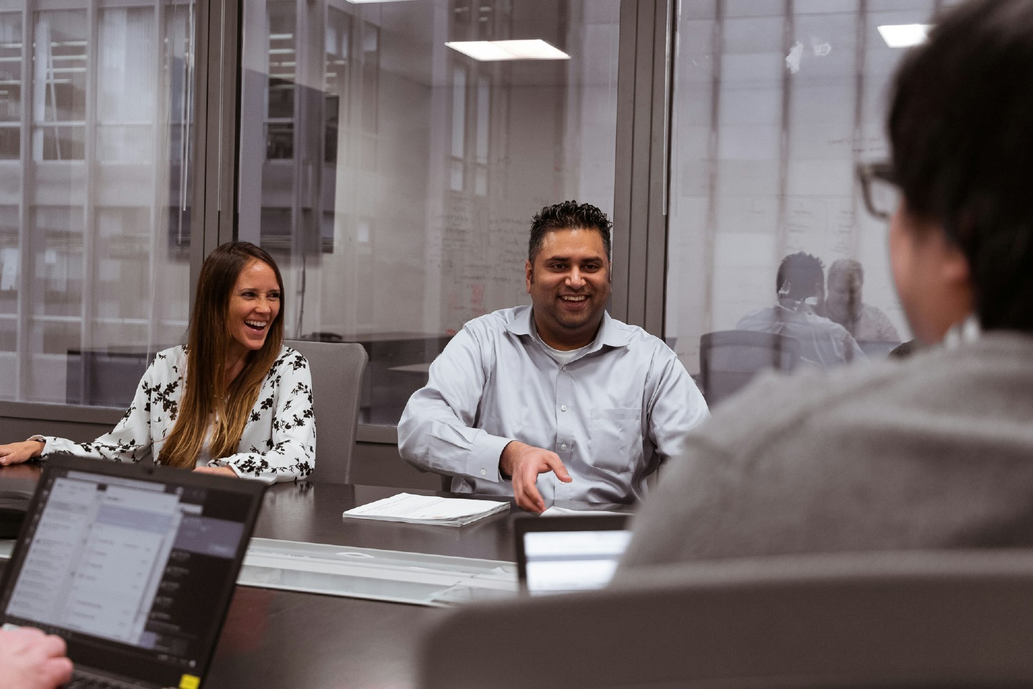 Consultant Marynelly Rondon Clavo and Project Manager Saad Mansuri laugh during a training session.