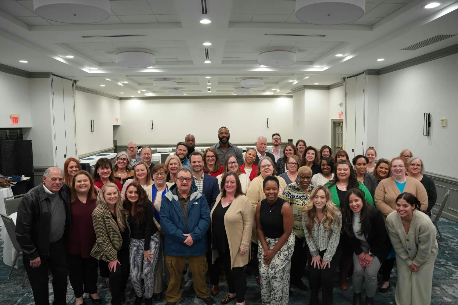 UNITY: Diverse, multigenerational workforce unites as one team. Company-wide gathering showcases inclusive environment.