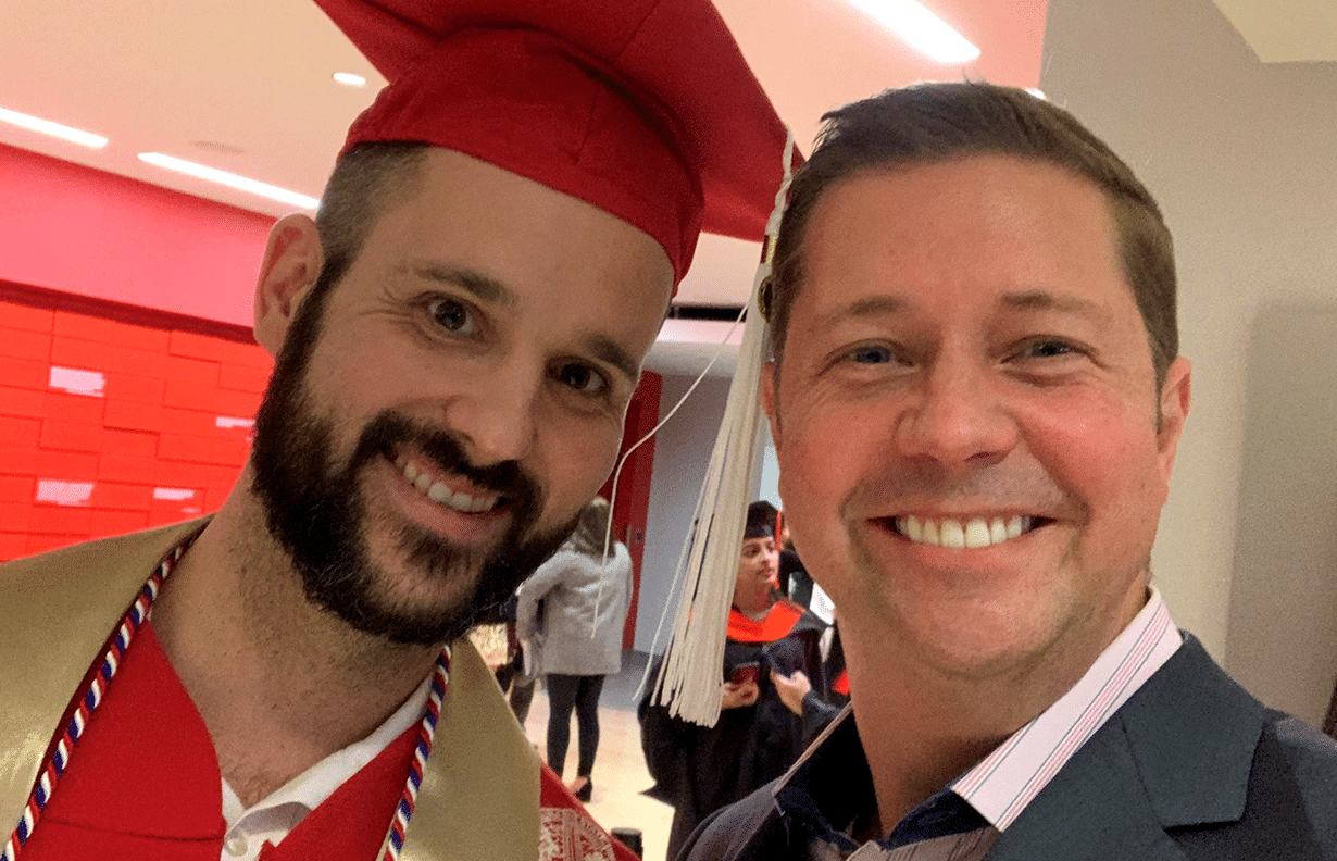 CEO Lindon Hayes congratulates VP of Innovation, Zack Raboin, at his graduation ceremony.