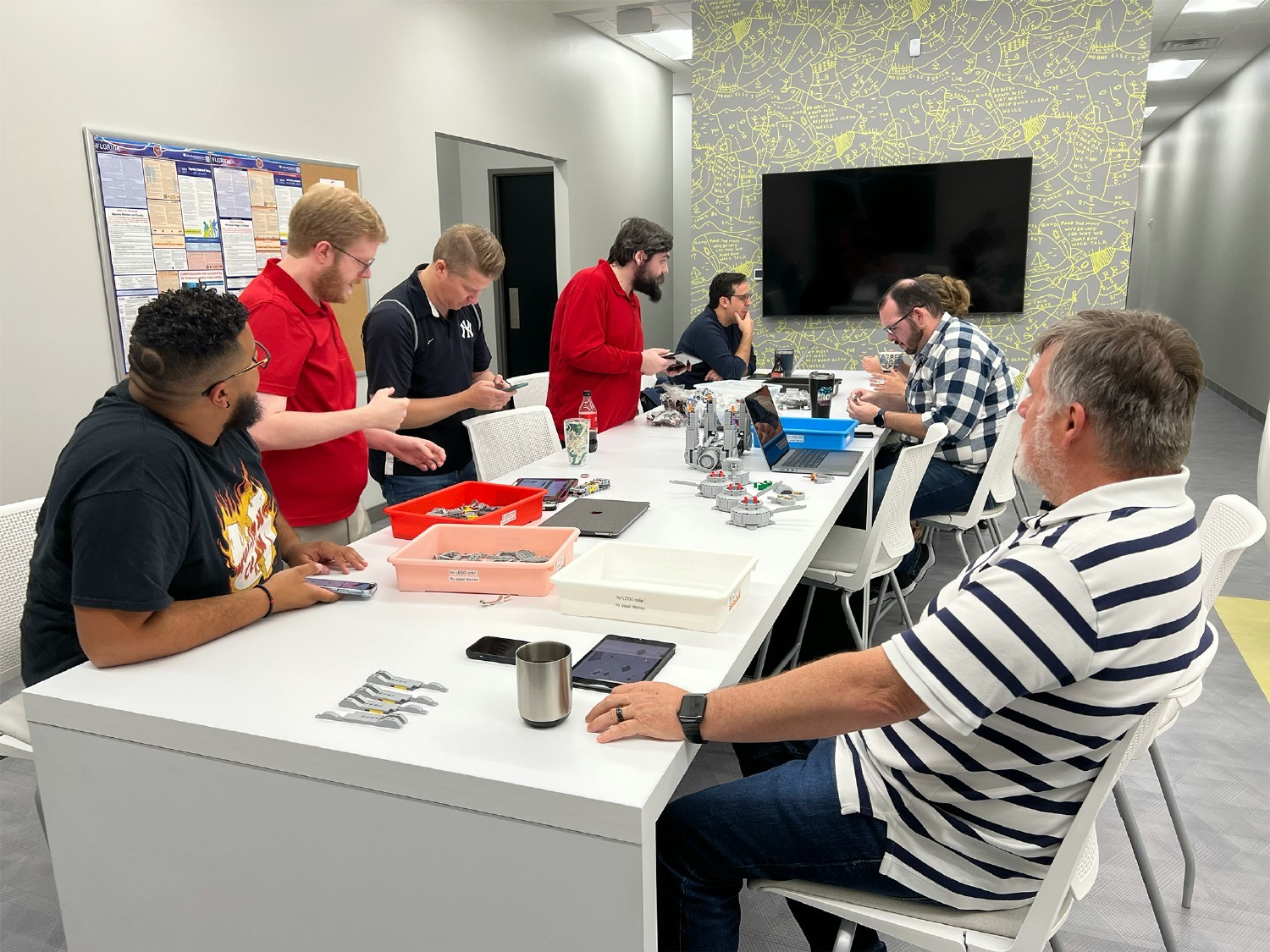 Metrc team members working together to build a LEGO set.