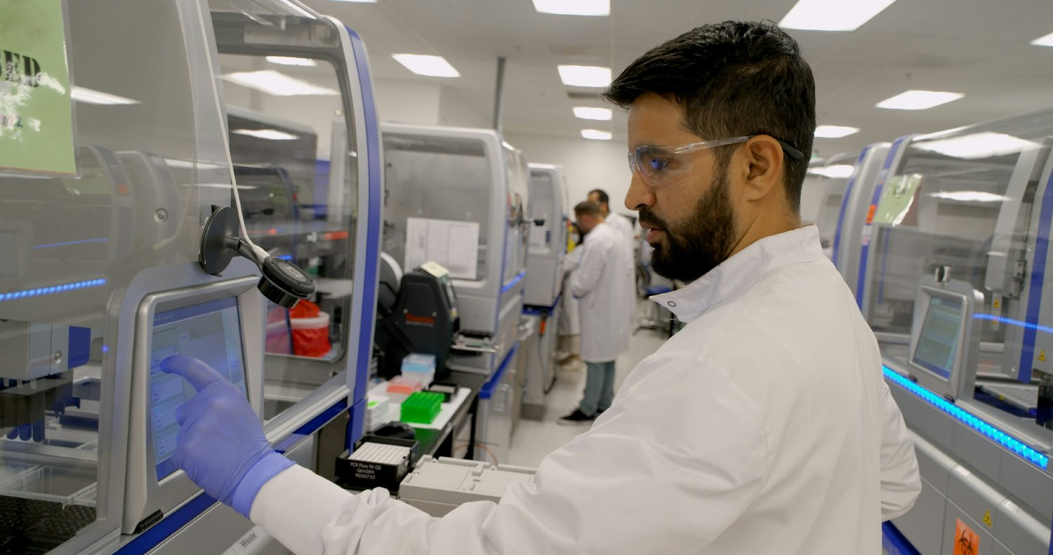 Lab employees processing samples that will return critical insights for doctors in the fight against cancer.