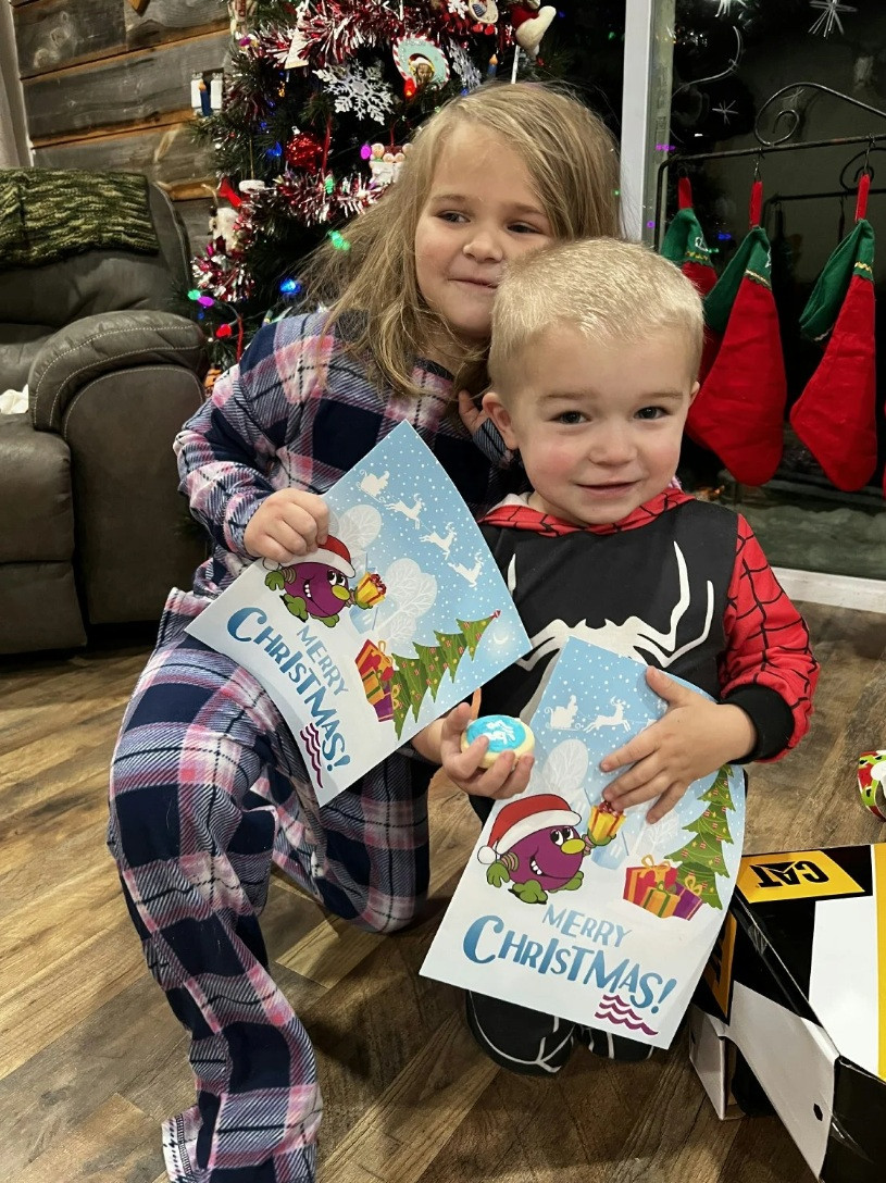 The Credit Union provides an annual Christmas present give-away for staff children/grandchildren.  Two happy kids shown 