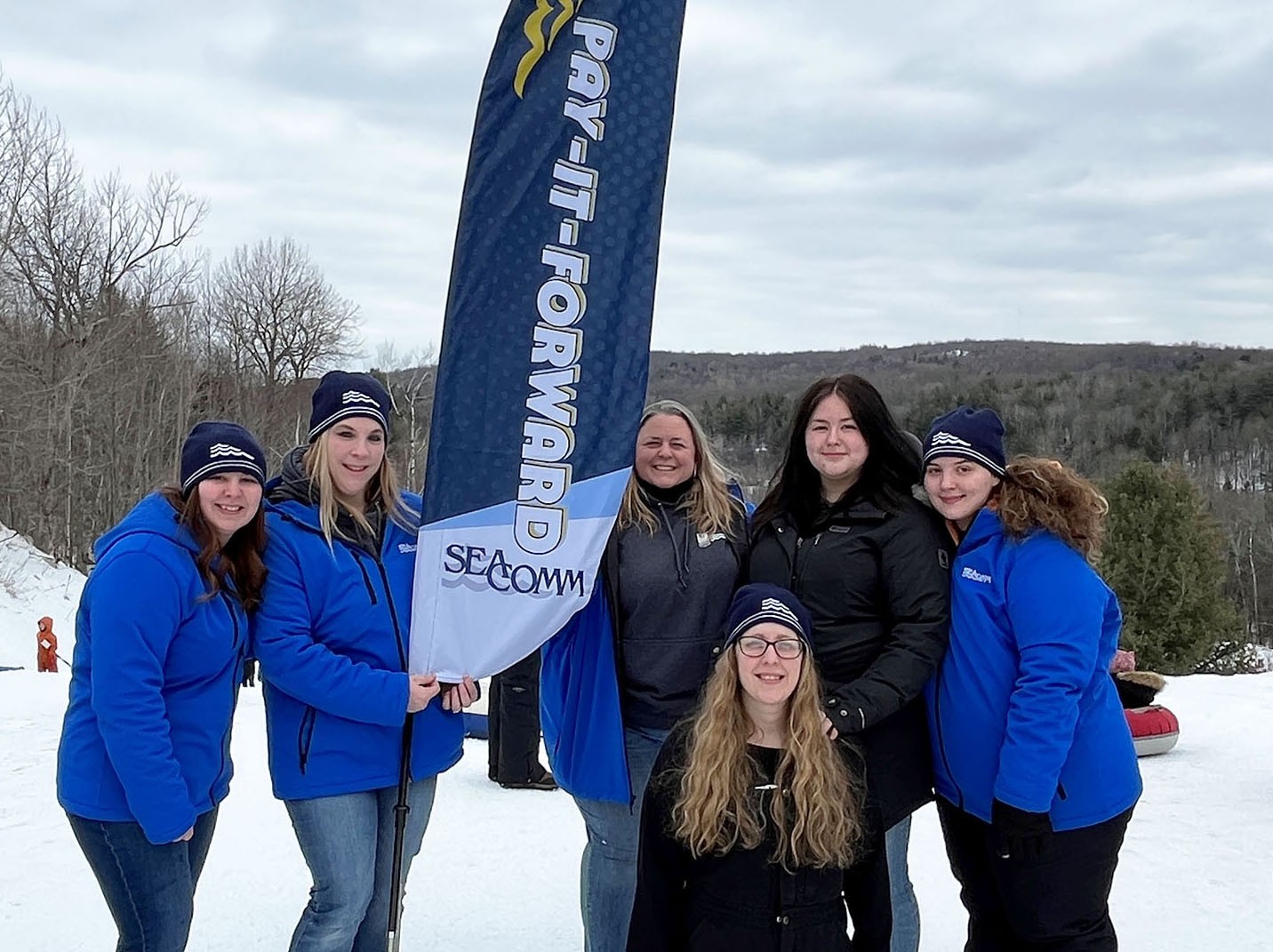 Staff out in the community with our Pay-It-Forward program shown at Titus Mountain providing free passes for tubing.