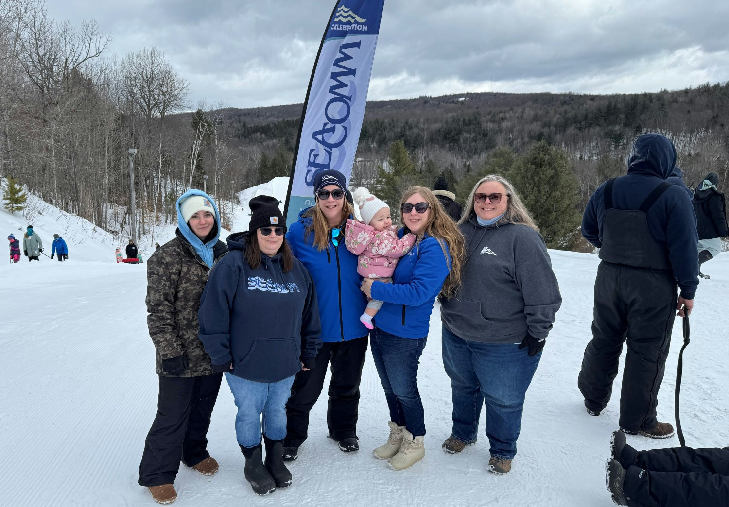 Staff out in the community with our Pay-It-Forward program shown at Titus Mountain providing free passes for tubing.