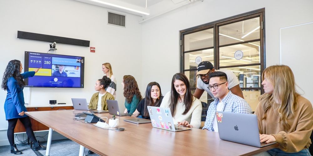 The monday.com team collaborating in the New York office.