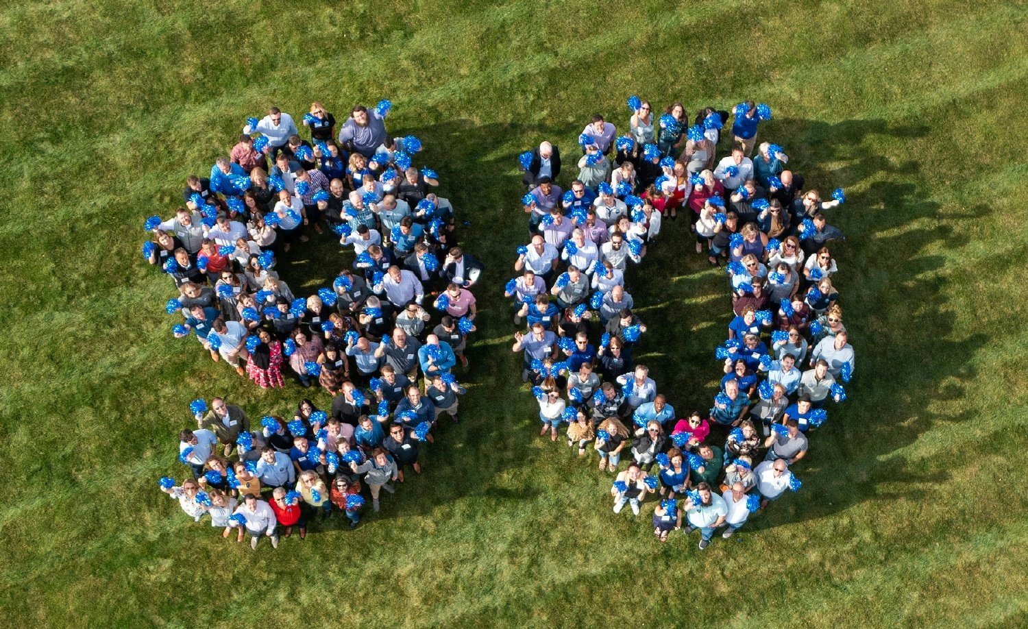Associates gather for a drone picture to celebrate the company's 90-year anniversary! 