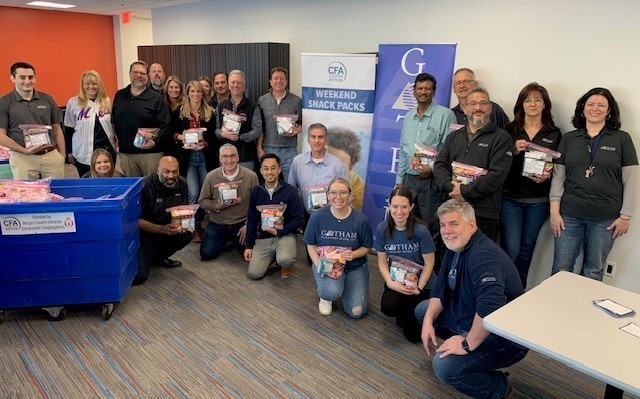 Gotham employees assemble 500 Snack Packs for the Center for Food Action