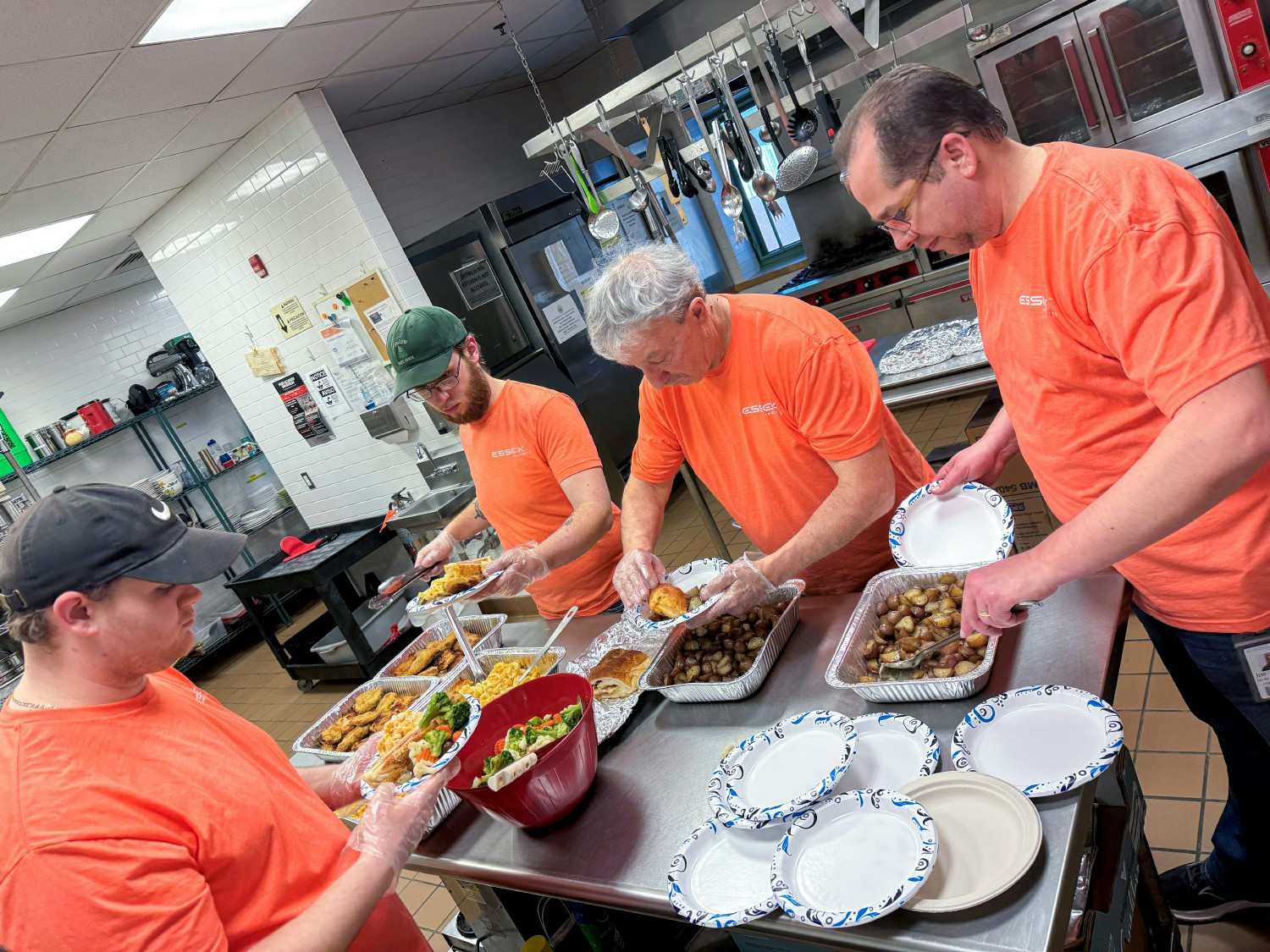 Essex Give volunteers from Milford prepared meals at Spooner House, supporting communities through paid volunteer days.