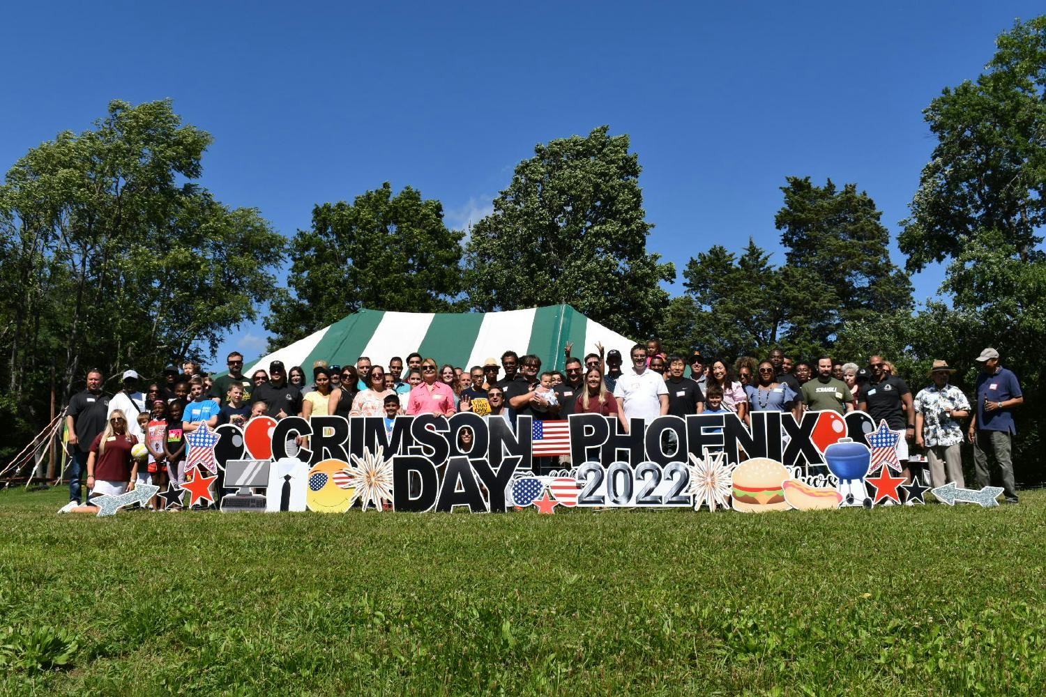 Group photo of employees and their families at Crimson Phoenix Picnic. 