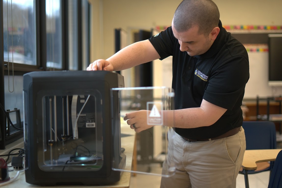 Jacob Ceccola, working on a 3D printer