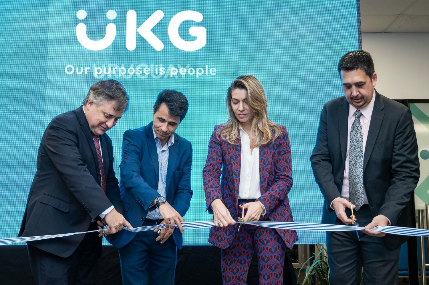 Celebrating our new office in Uruguay with a ribbon-cutting ceremony.