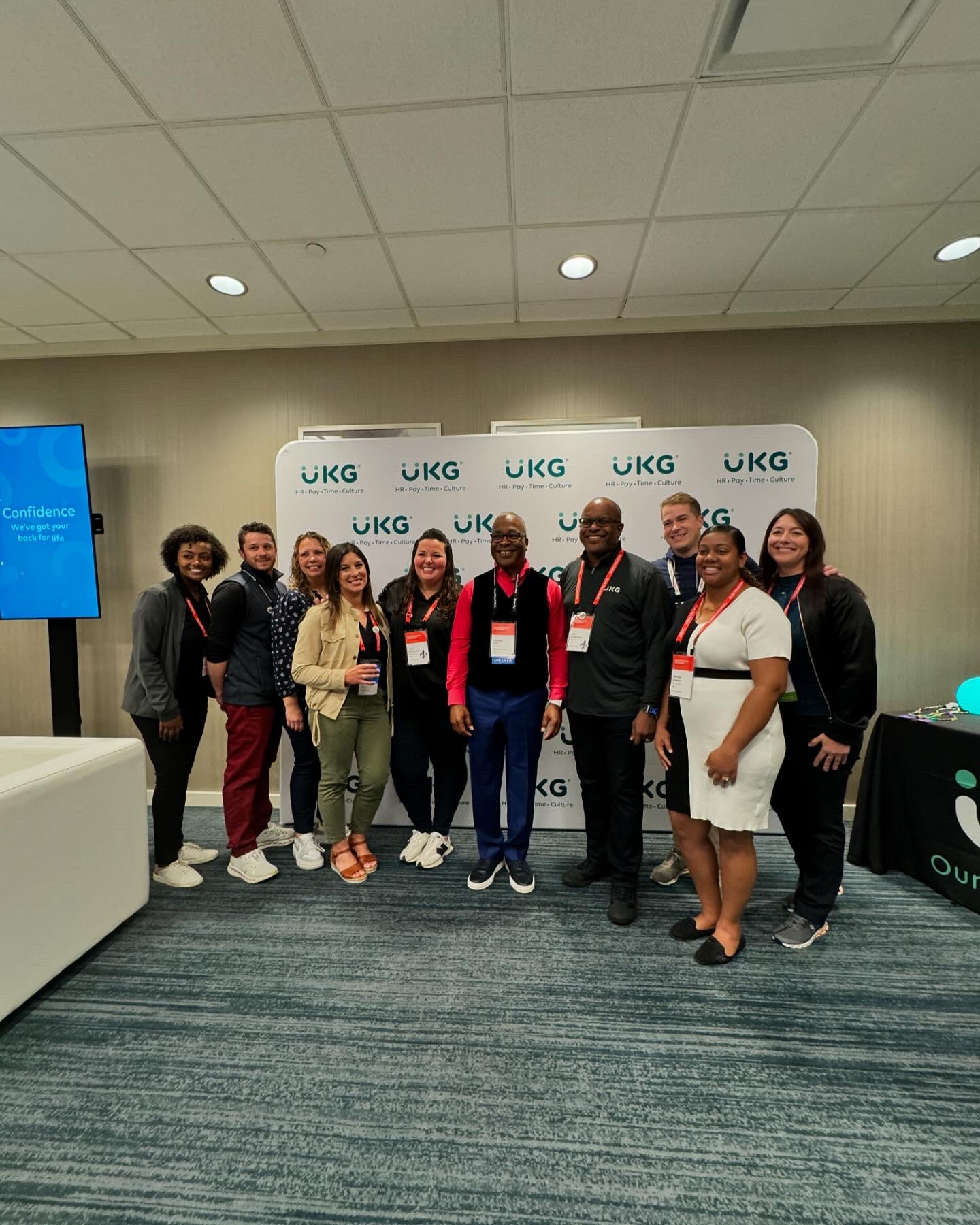 Attendees at UKG's booth at the Great Place To Work's 2024 For All Summit
