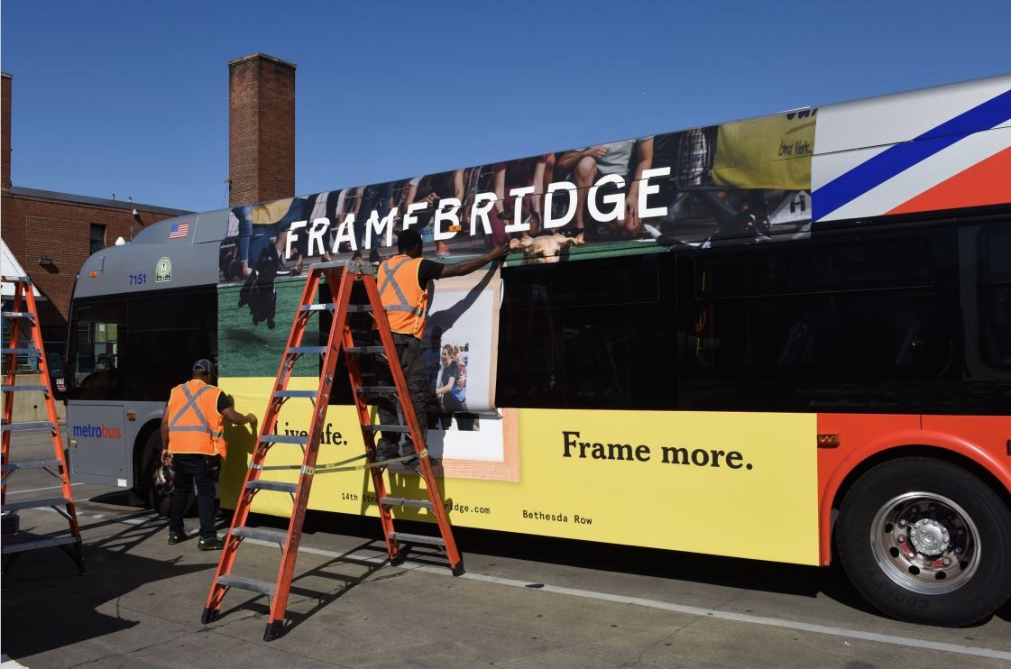 Operations Crew wrapping a bus. 