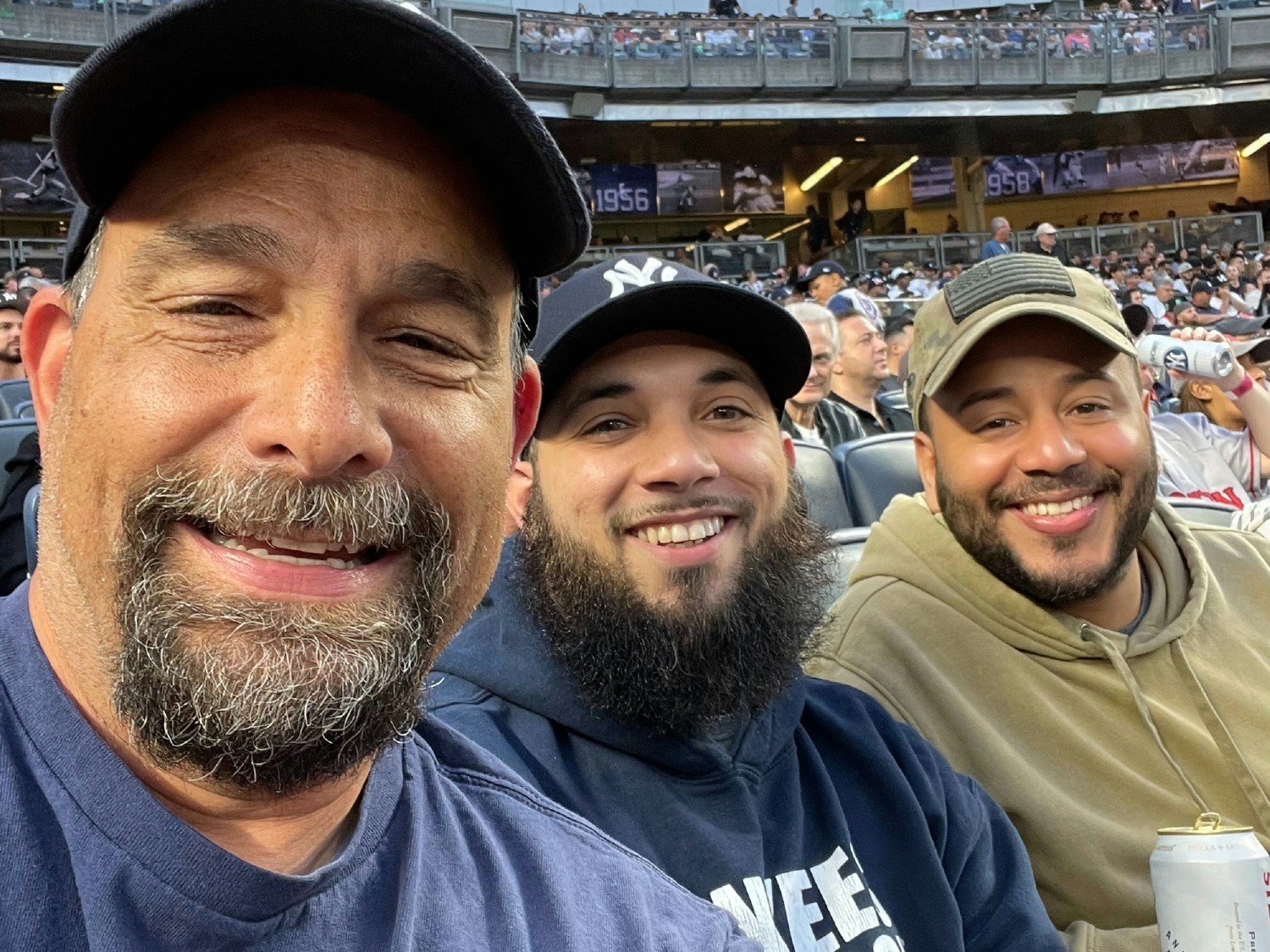 Team members Bob, Niko, and Adams enjoying a Yankees game.