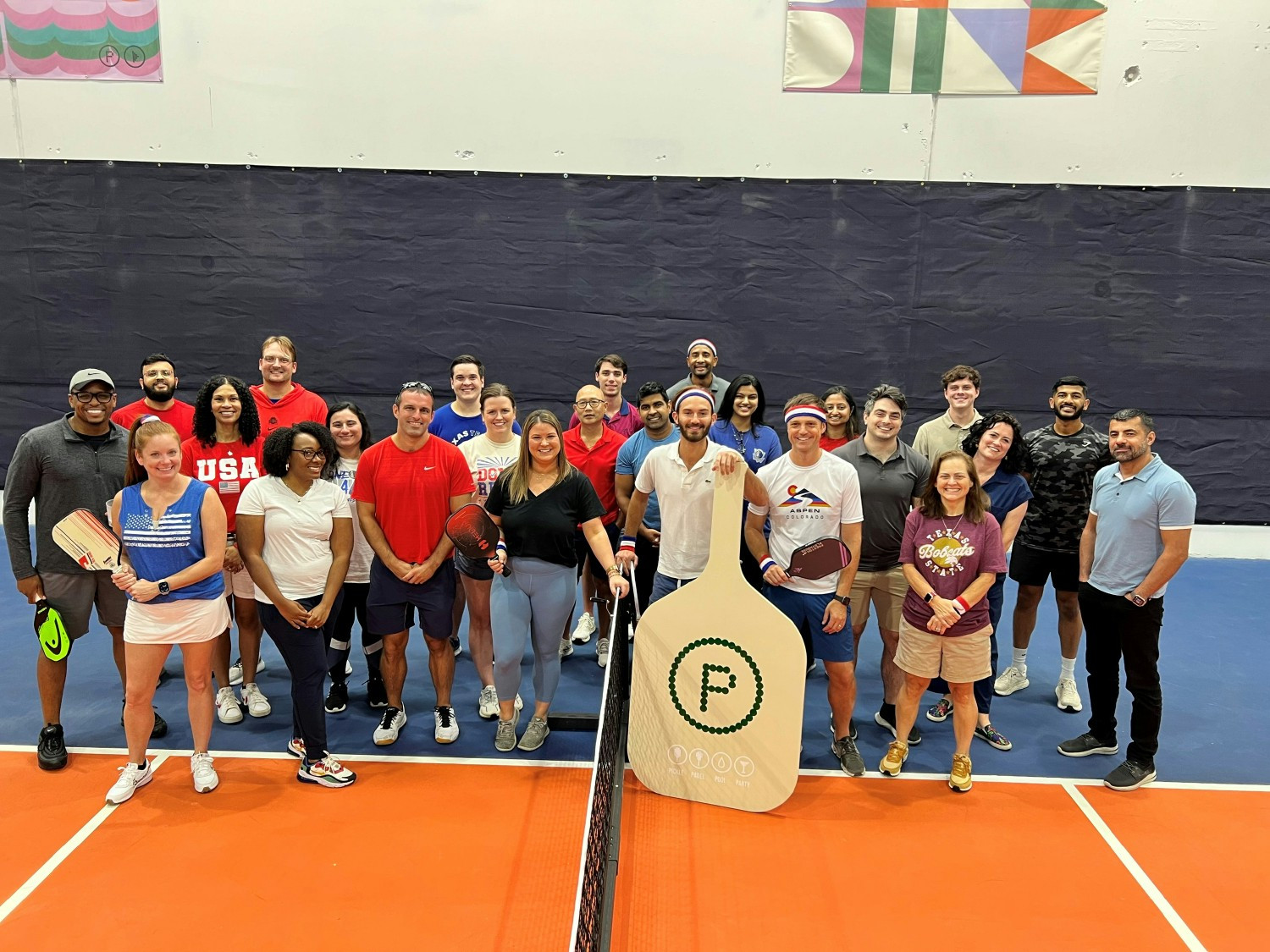 Dallas colleagues have fun facing off in a team pickleball tournament!