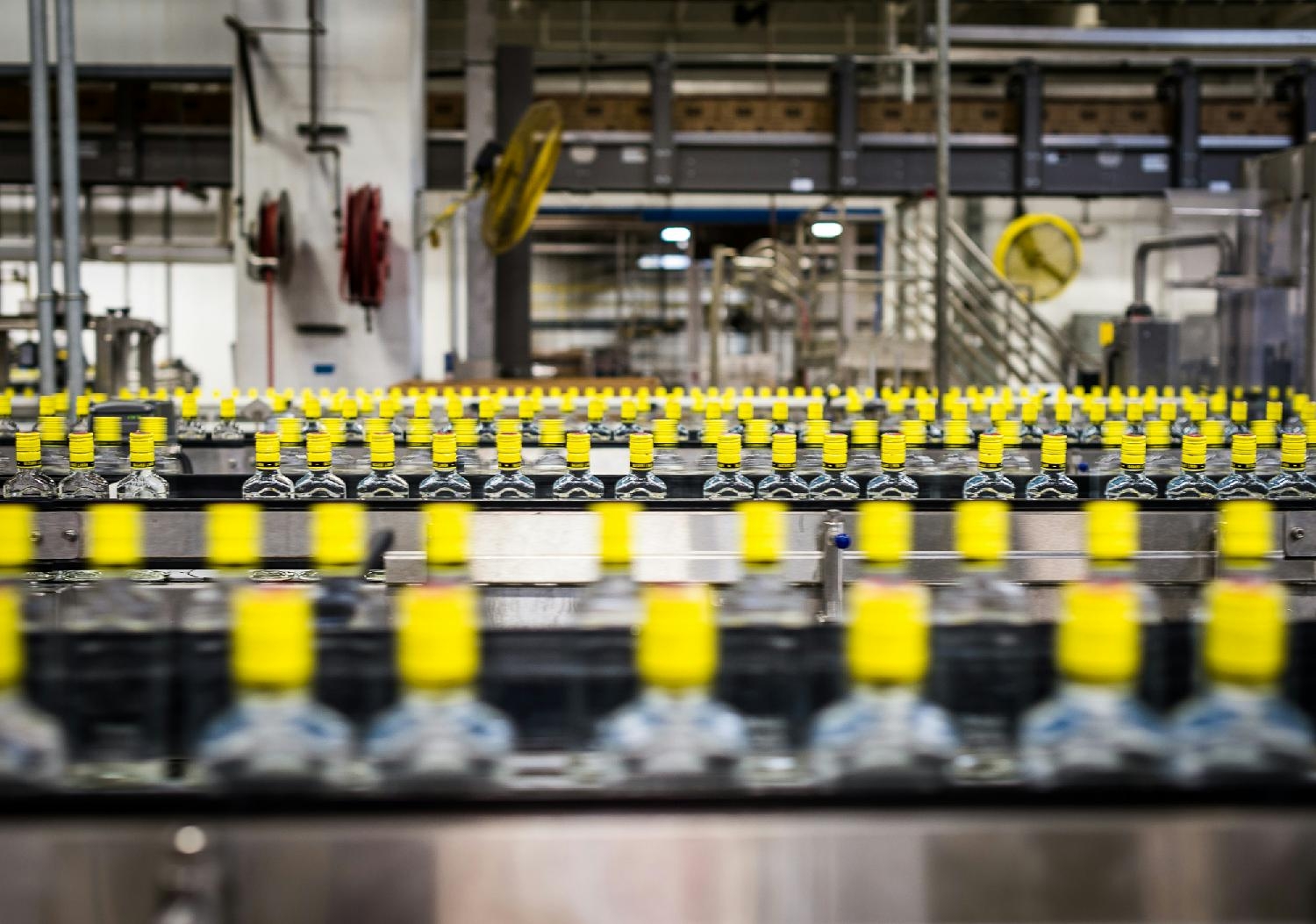 BOTTLES PROGRESSING DOWN THE PRODUCTION LINE