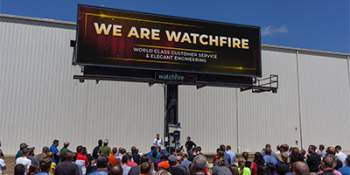 Watchfire team beneath a billboard product at Danville location.