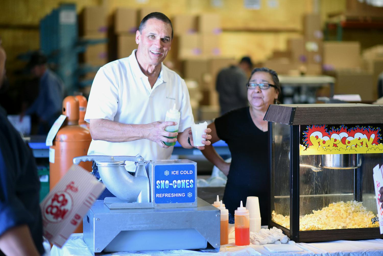 Management serves refreshments at a Customer Appreciation Day