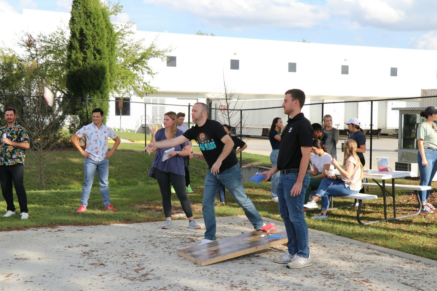 AgAmericans competing in a cornhole competition at an after-hours event. 