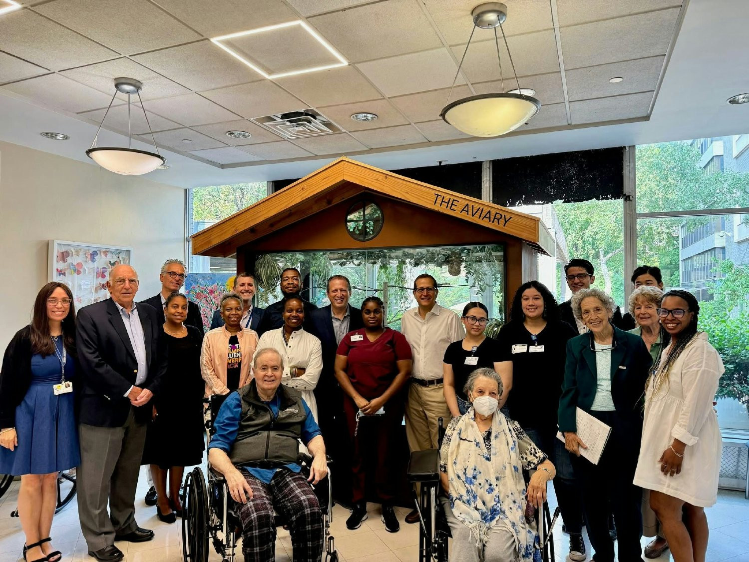 Board members, staff, and residents together in our atrium, celebrating our workforce development community spirit. 