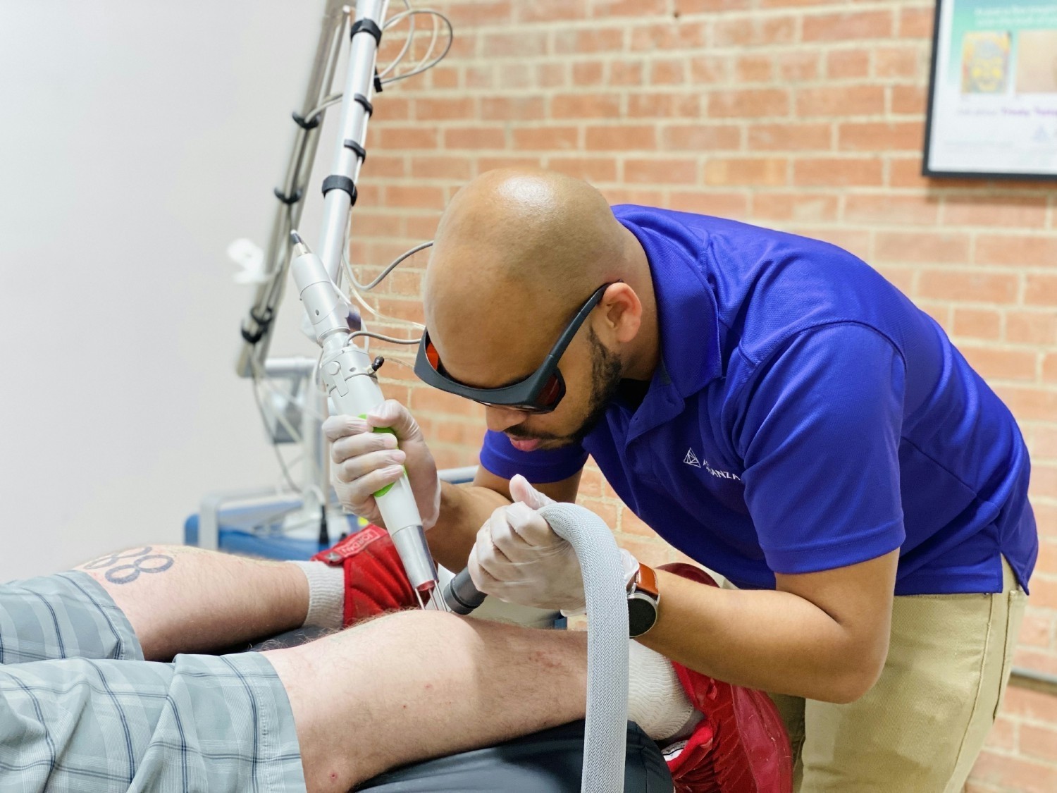 A PICTURE DURING OUR LASER TATTOO REMOVAL COMMUNITY DAY WHERE WE PROVIDE NO - COST TREATMENTS. 