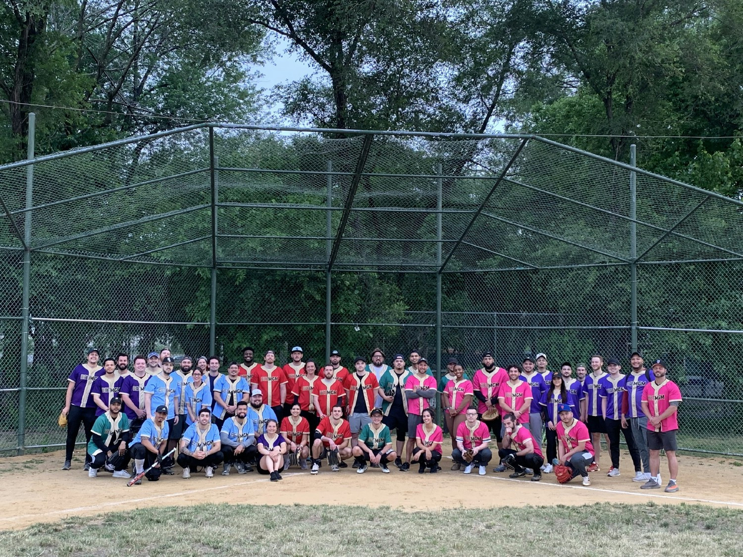 Employees enjoying friendly competition at BetMGM's softball league finals.