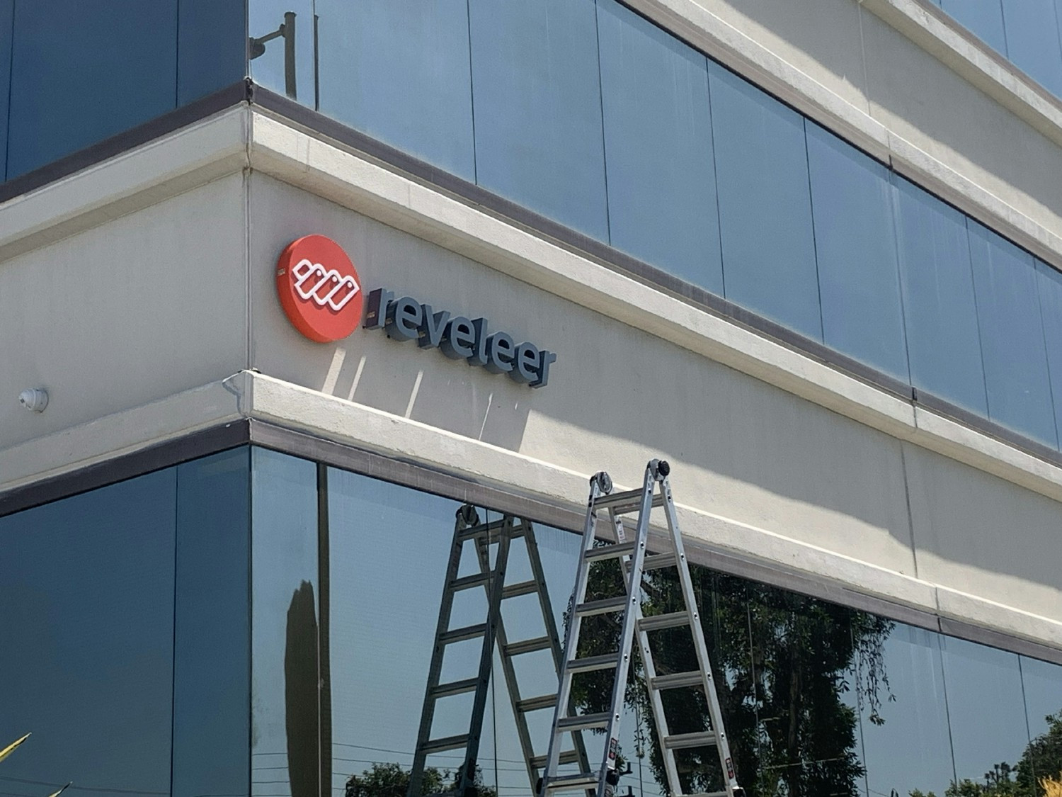 Reveleer Photo of the Year: Climbing to new heights - celebrating our company name sign at our company headquarters 
