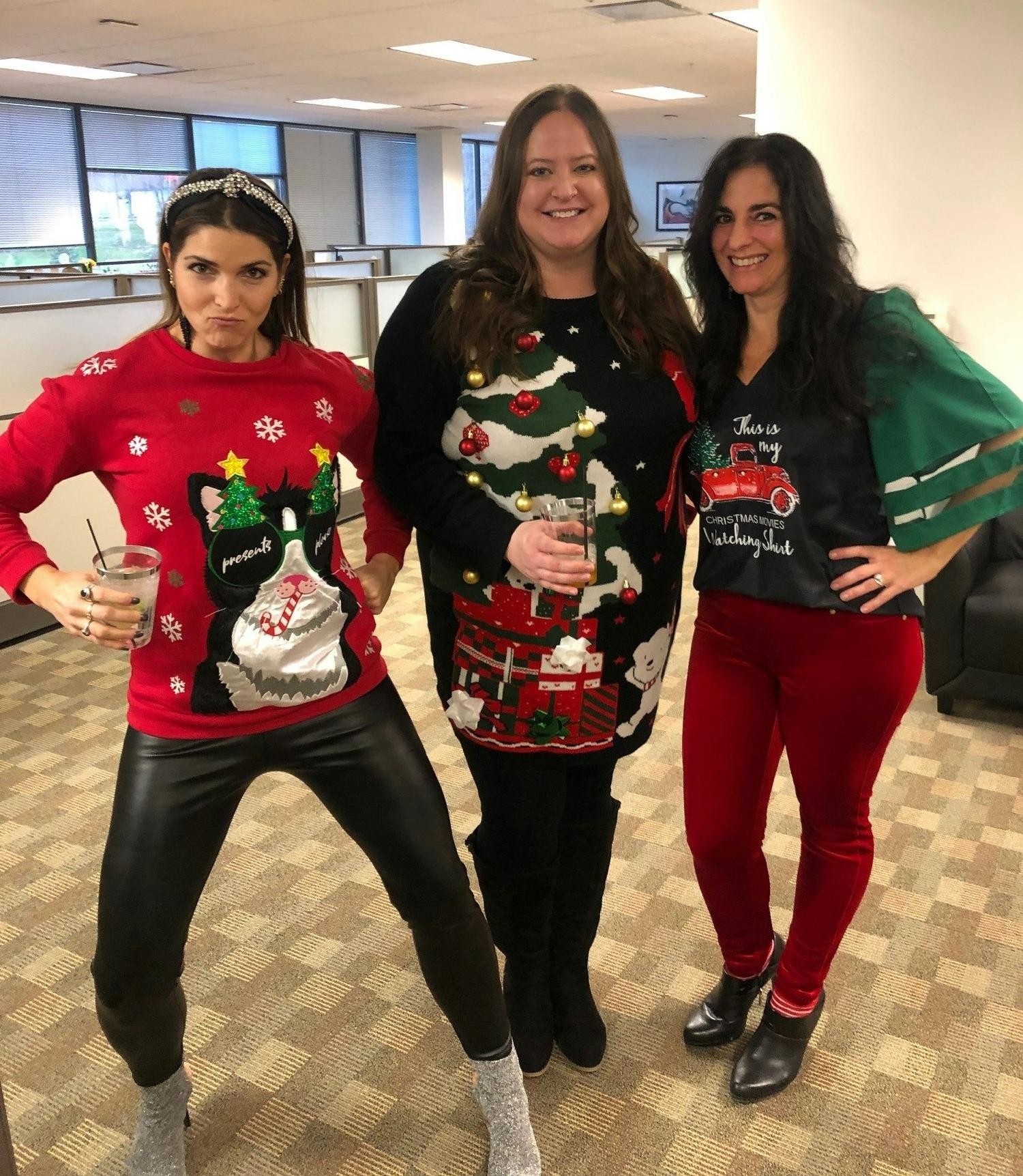 Contestants of an ugly sweater contest during an office holiday party