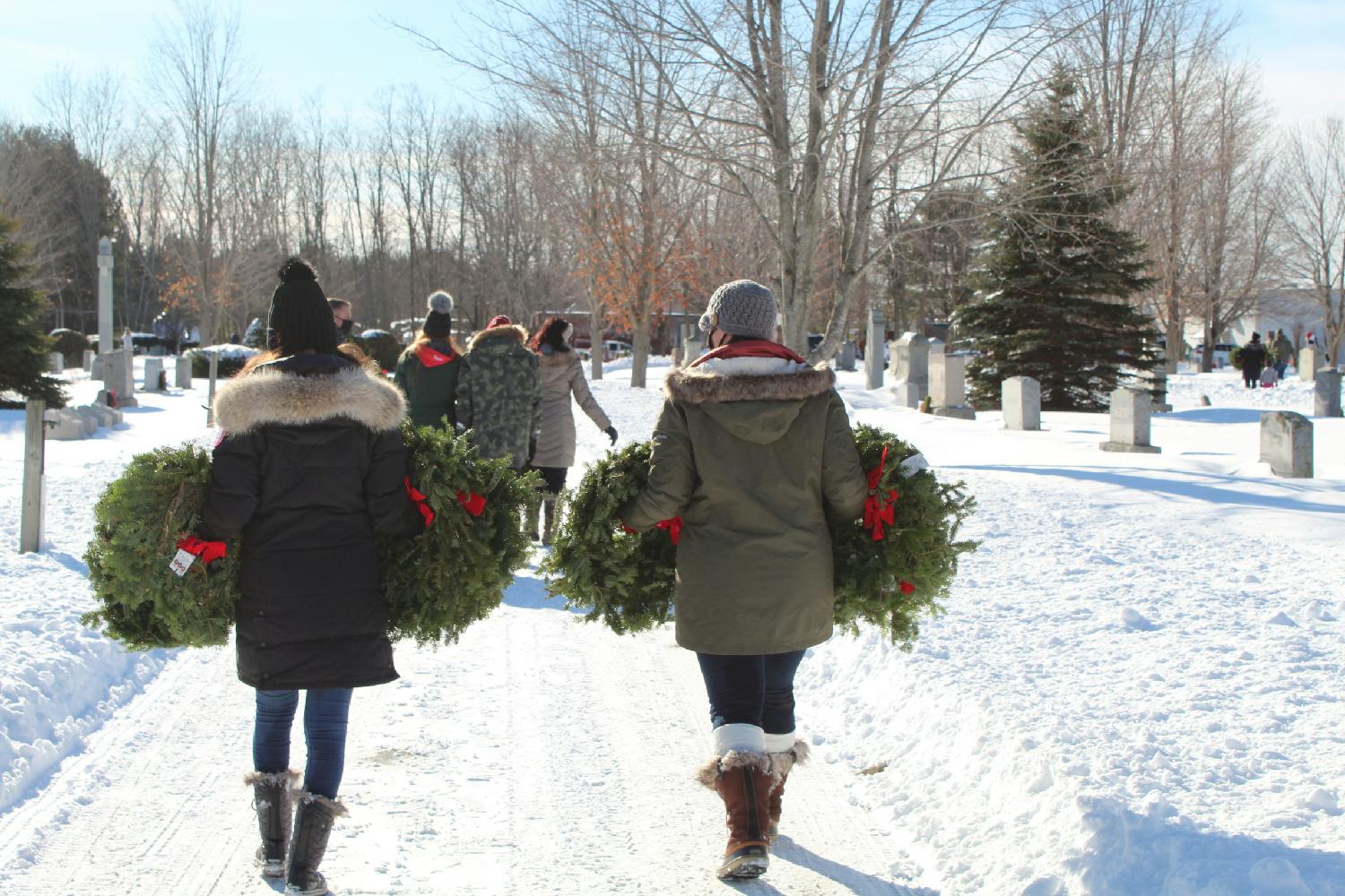 Employees participate in Wreaths Across America event in Biddeford, Maine laying 3,000 wreaths on the graves of veterans