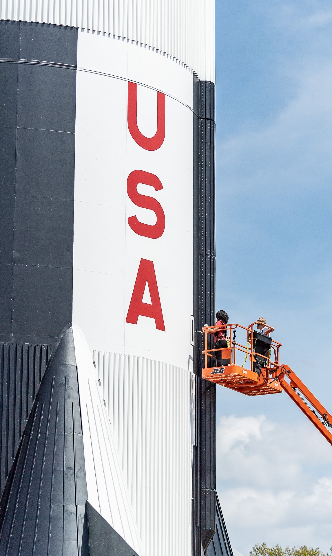 ERC supporting the fresh coat of paint on Saturn V at the US Space & Rocket Center.