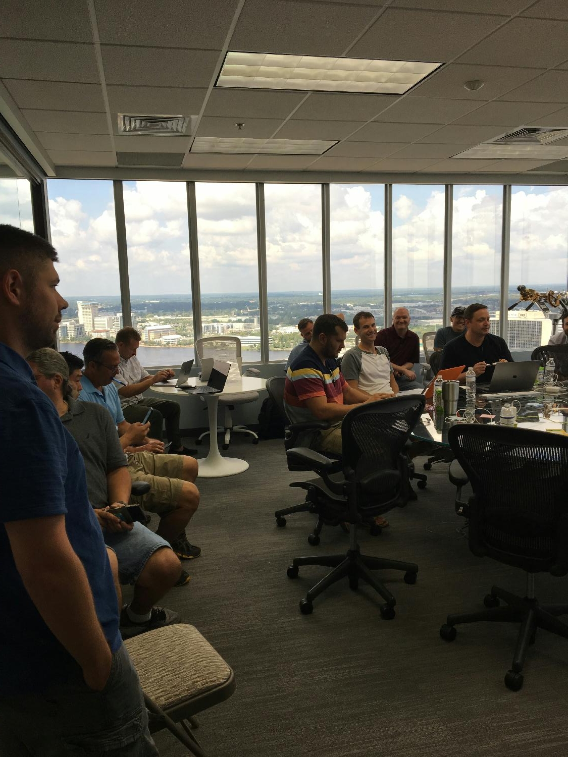 Employees gather in the Boardroom (casual attire is our norm).