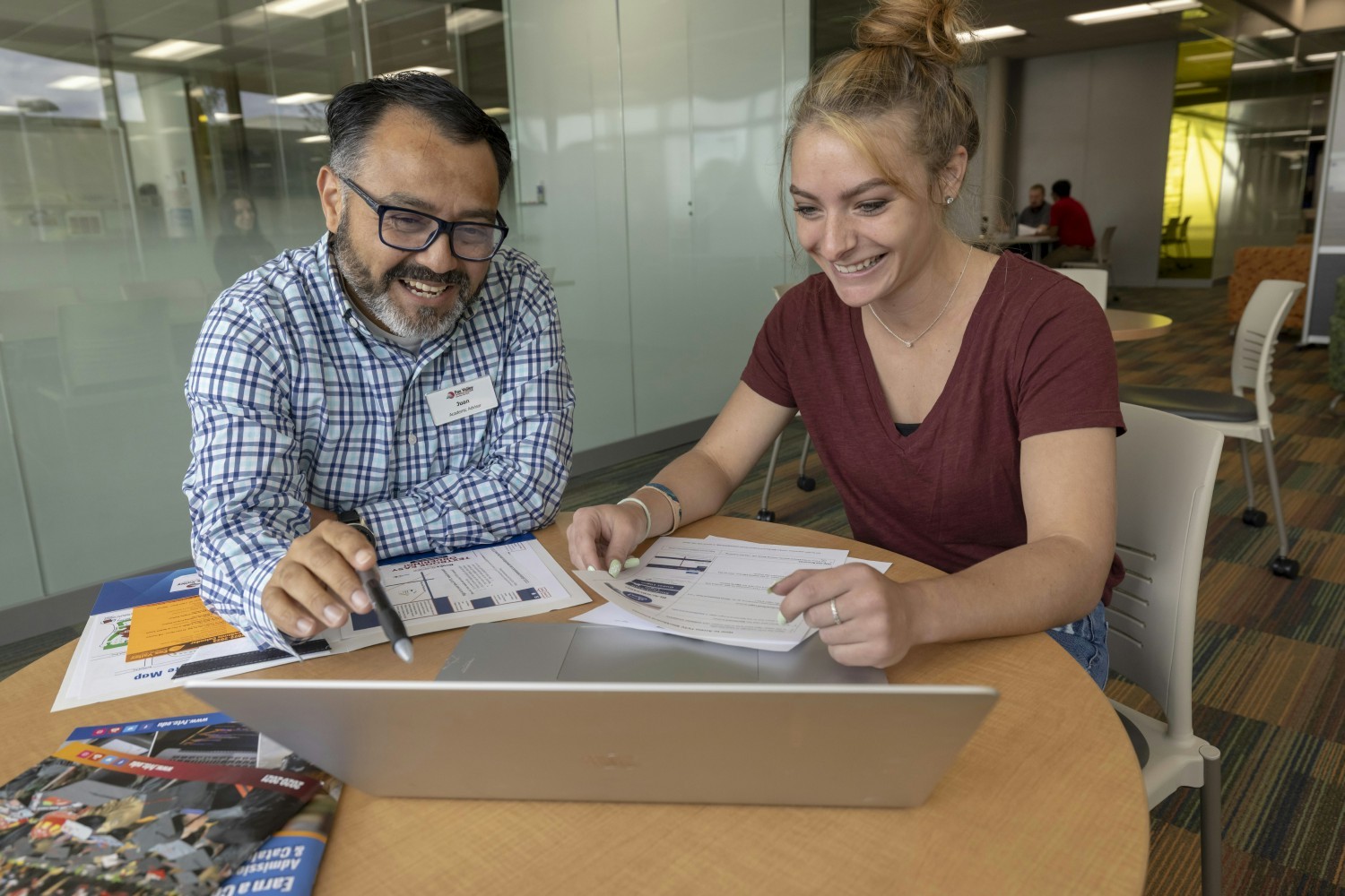 Staff member, Juan Valdez, assisting a student