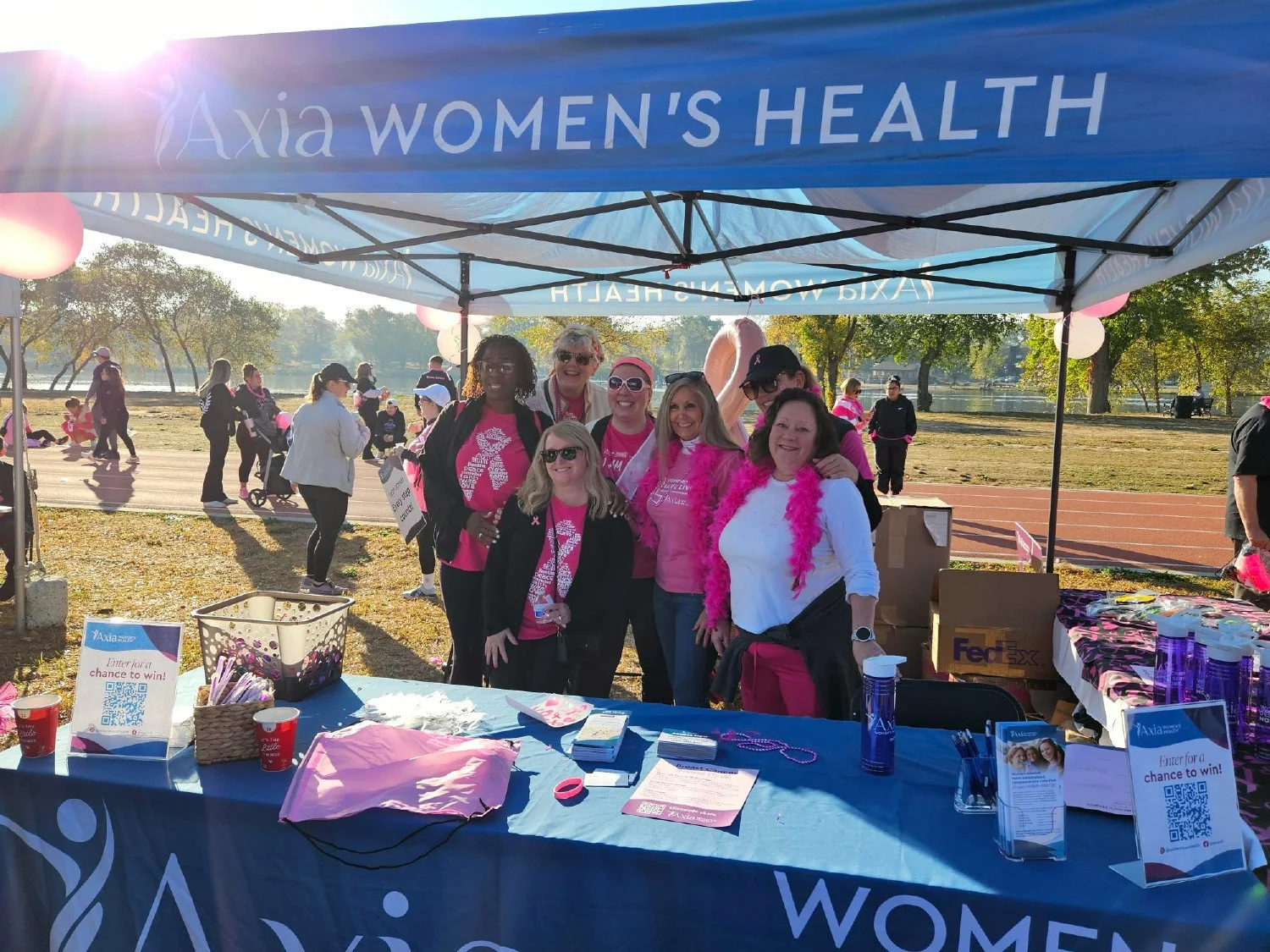 Axia colleagues volunteer at a community event to honor Breast Cancer Awareness Month