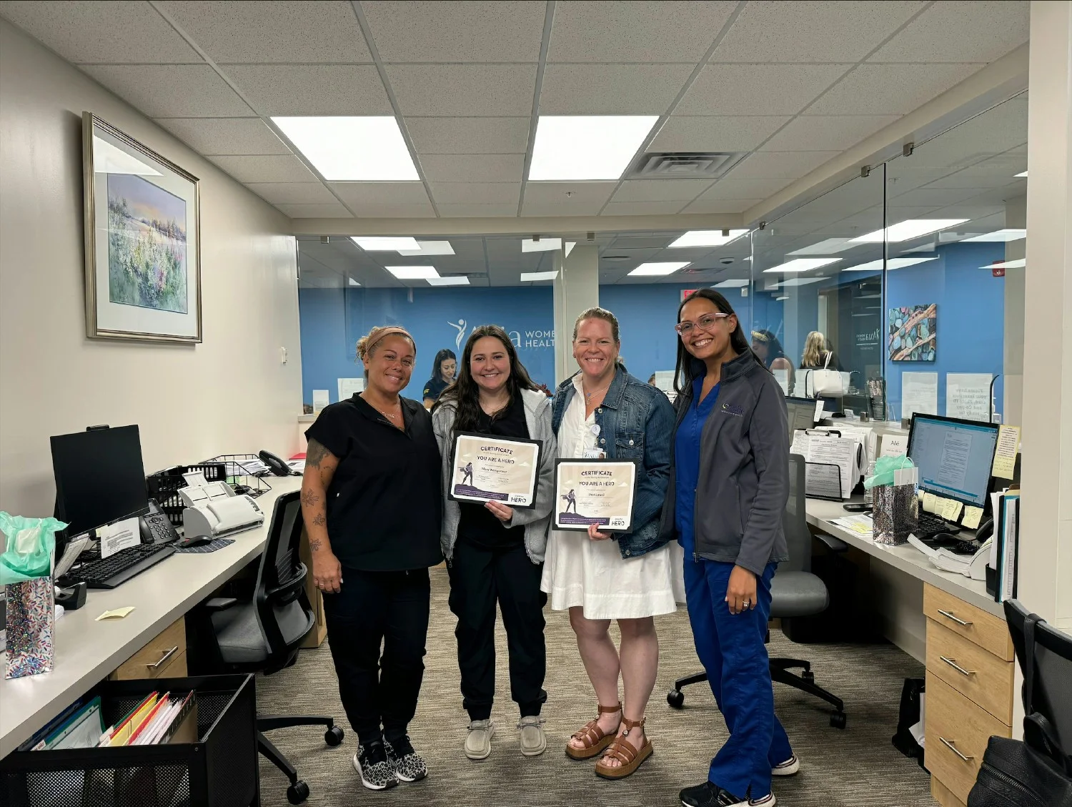 Axia colleagues recognizing their Axia Hero winners during Breast Cancer Awareness Month