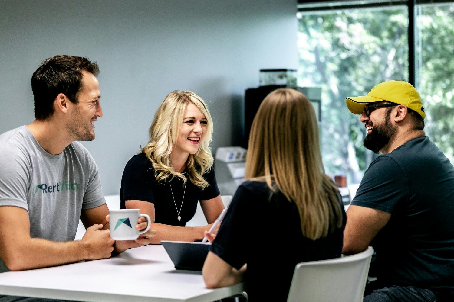 Co-workers enjoying free coffee and collaborating on a group project. 